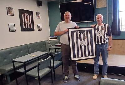 Supporters Club Secretary receiving a framed shirt from Brian Shippen