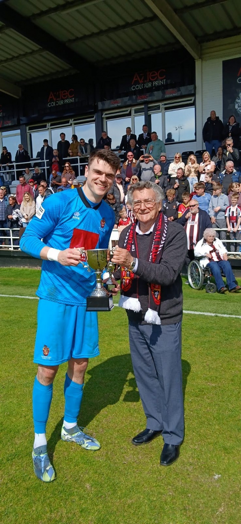 Brad James receiving the prestigious Connie Wailes Memorial Trophy from Supporters Club Treasurer Ernie Hamer
